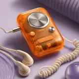 Transparent orange retro music player with wired earbuds on a lavender surface