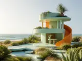 Mint-green circular beach house with an orange spiral staircase
