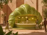 Pistachio-shaped dessert kiosk in a warm courtyard